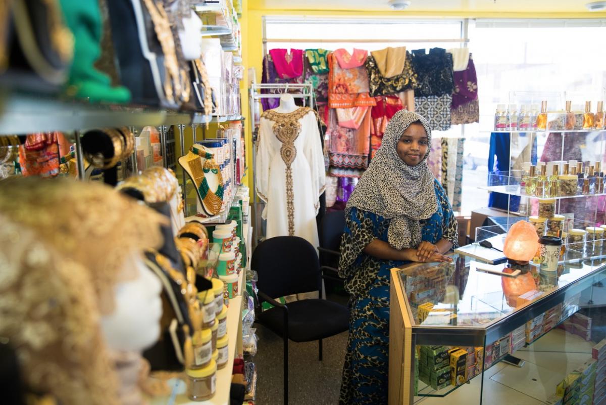 A woman stands at the counter of a bridal shop